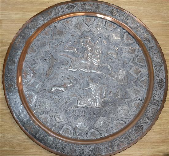 A Persian white metal mounted copper charger diameter 58cm